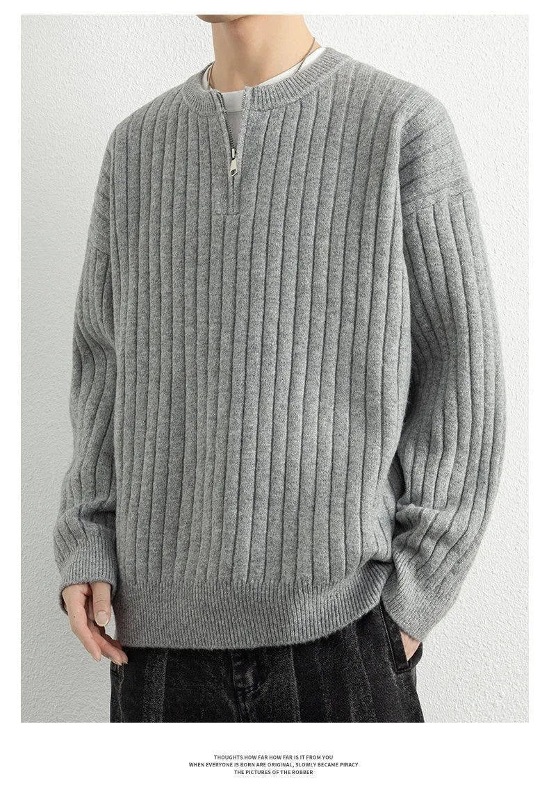 Man wearing a grey half-zip textured knit sweater, loose fit, long sleeves.