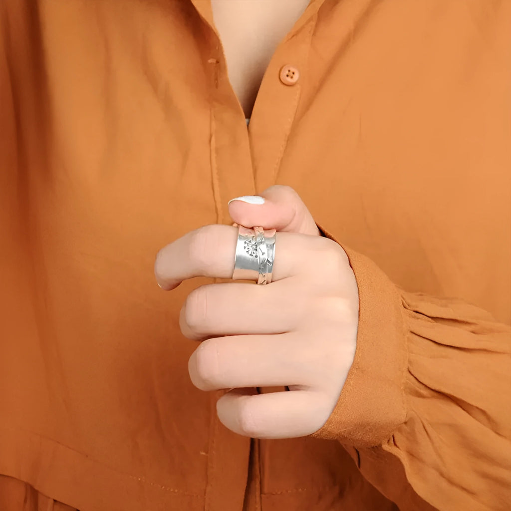 Silver rotatable flower fashion ring showing floral design and adjustable element