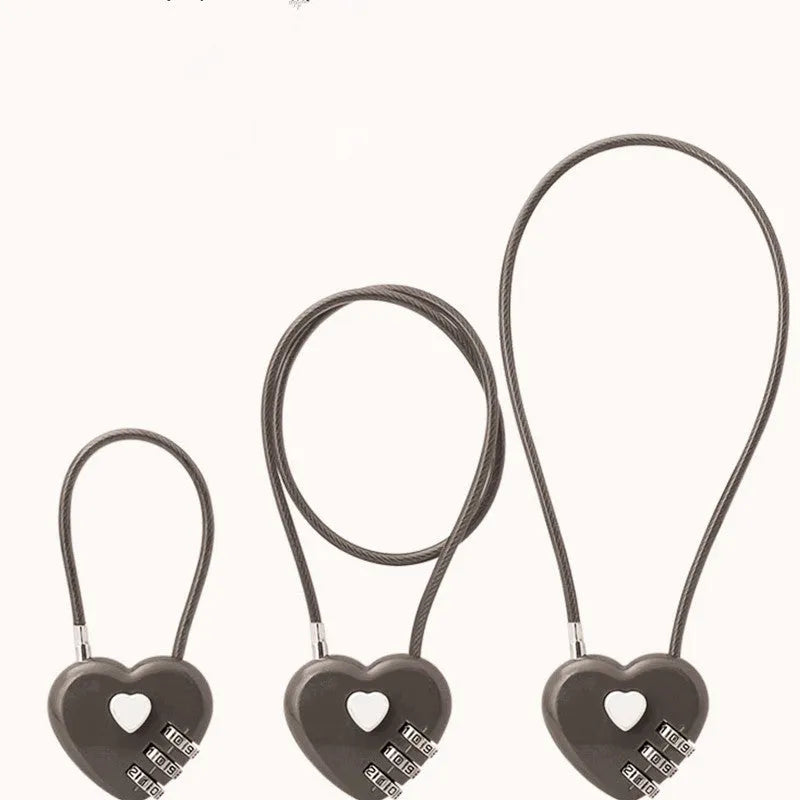 Peach heart design wire rope cable lock in red with steel rope, shown securing a bicycle helmet.