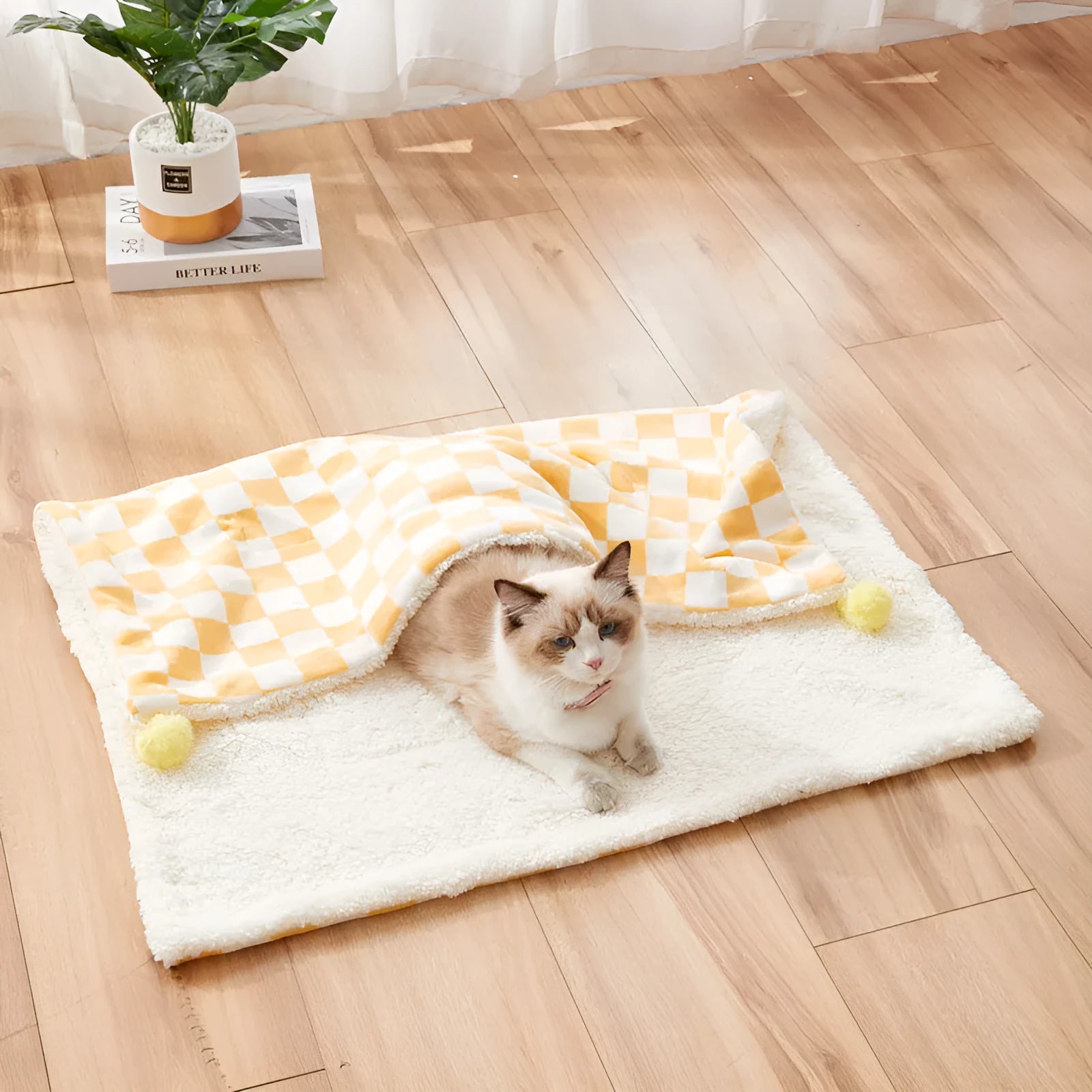 Green plaid pattern pet blanket with fur ball decoration on sofa