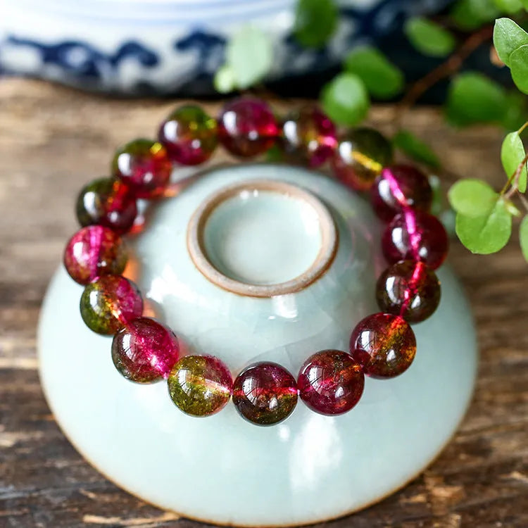 Handmade watermelon-coloured crystal bracelet for women shown in casual style.