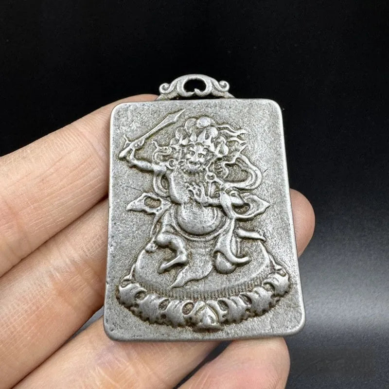 Close-up of iron Chinese style geometric pendant ornament featuring Aryaacalanatha Yamantaka motif.