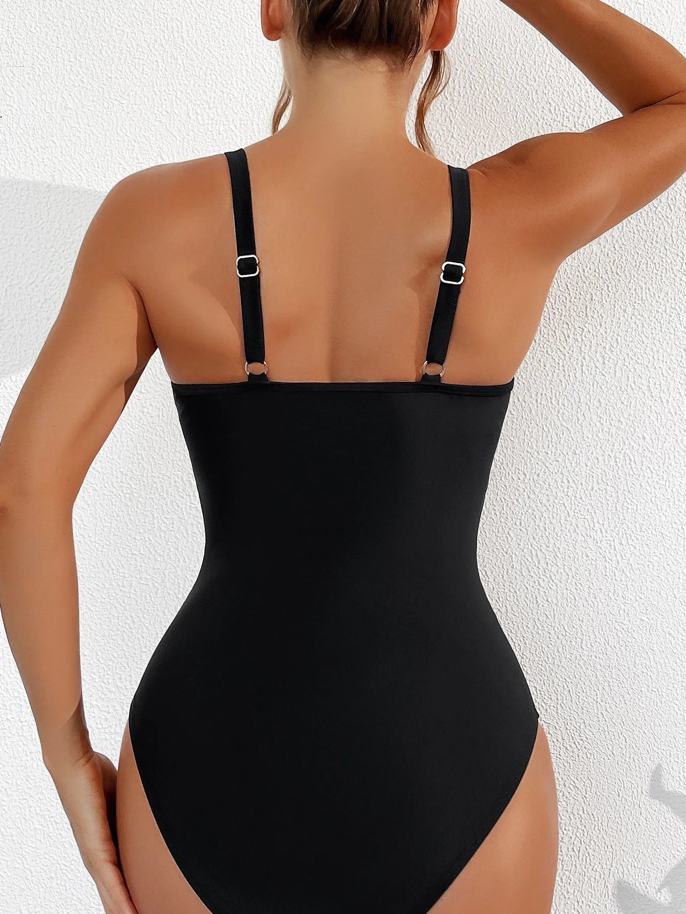 Black women's halter neck one-piece swimsuit with mesh detailing and briefs style cut