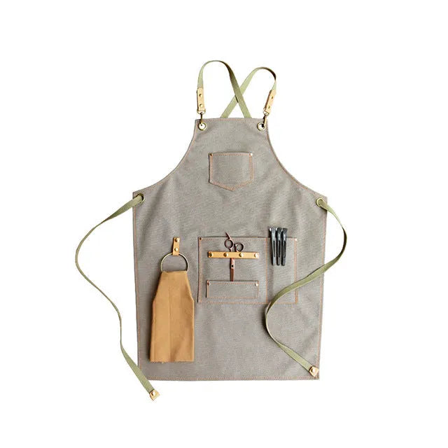 Canvas cross-back apron in camel colour on a mannequin, showing adjustable neck and waist ties