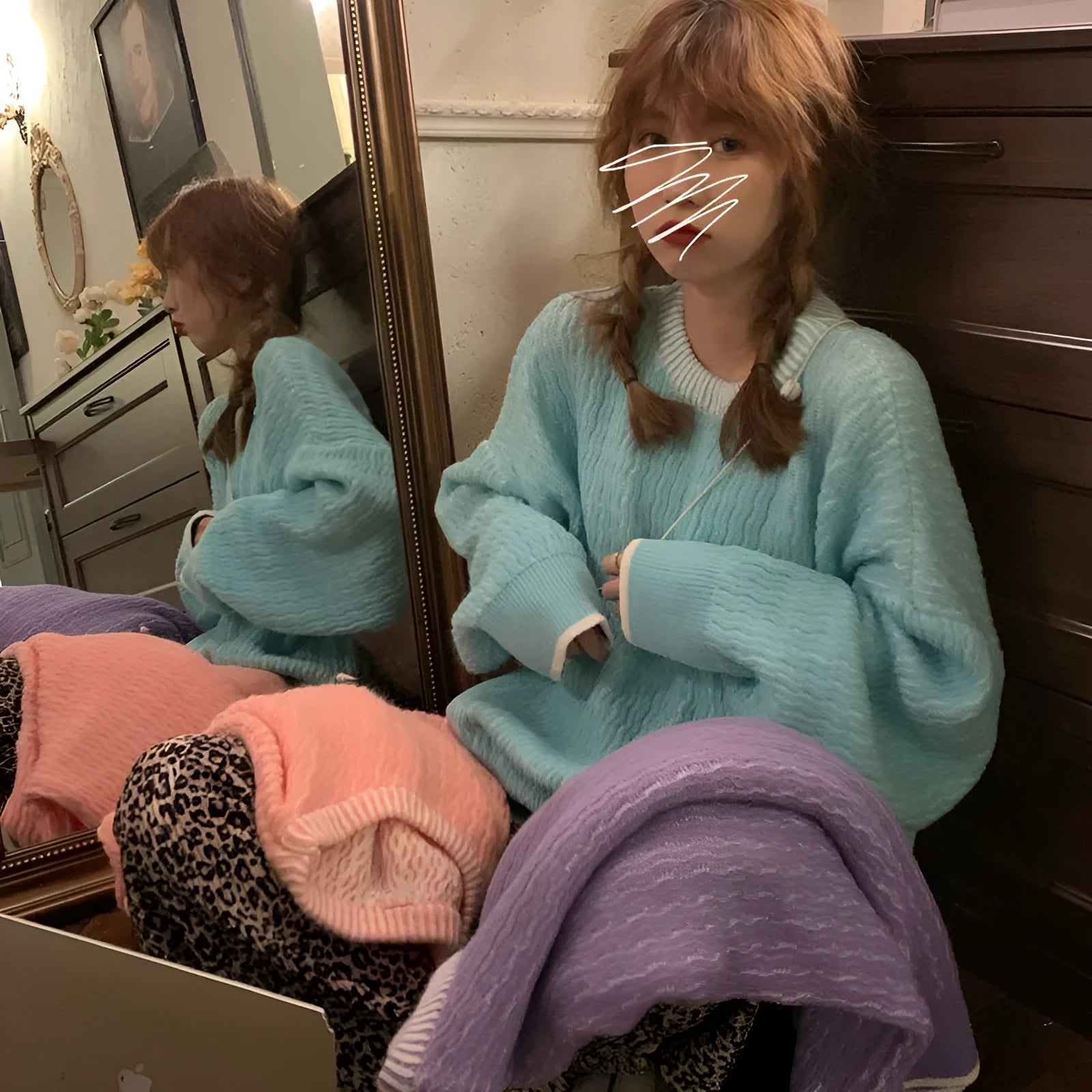 Women's lake blue loose retro pullover sweater with regular sleeves on a hanger.
