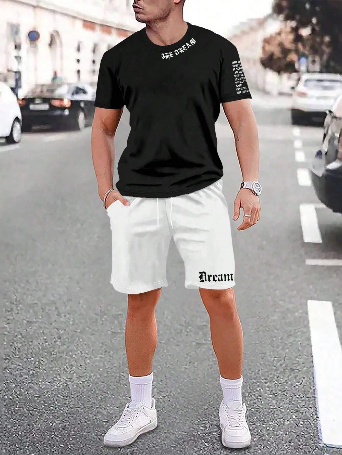 Man wearing a grey short-sleeve top and matching shorts from a sports co-ord set.