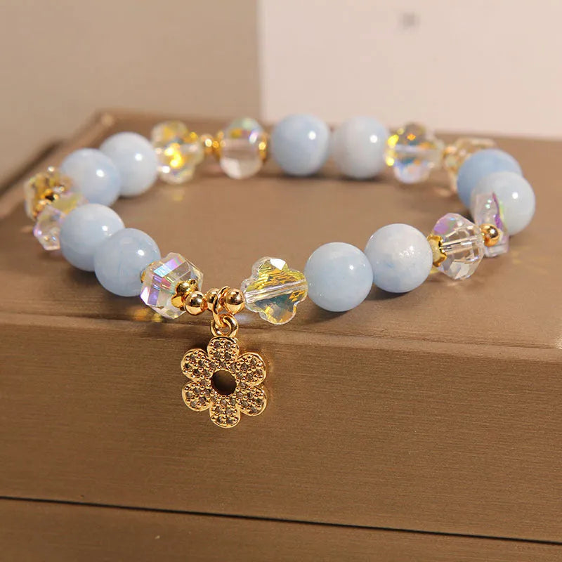Women's aquamarine crystal bracelet with four-leaf clover charm and pearl accents in light luxury design