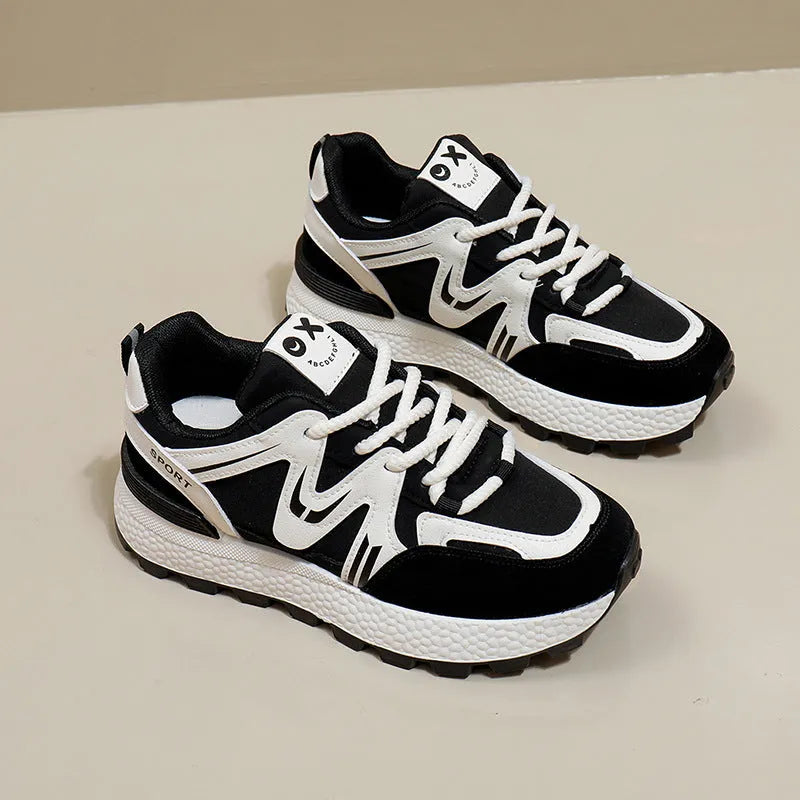 Women's black platform casual lace-up trainers with a round toe and flat heel on a white background.