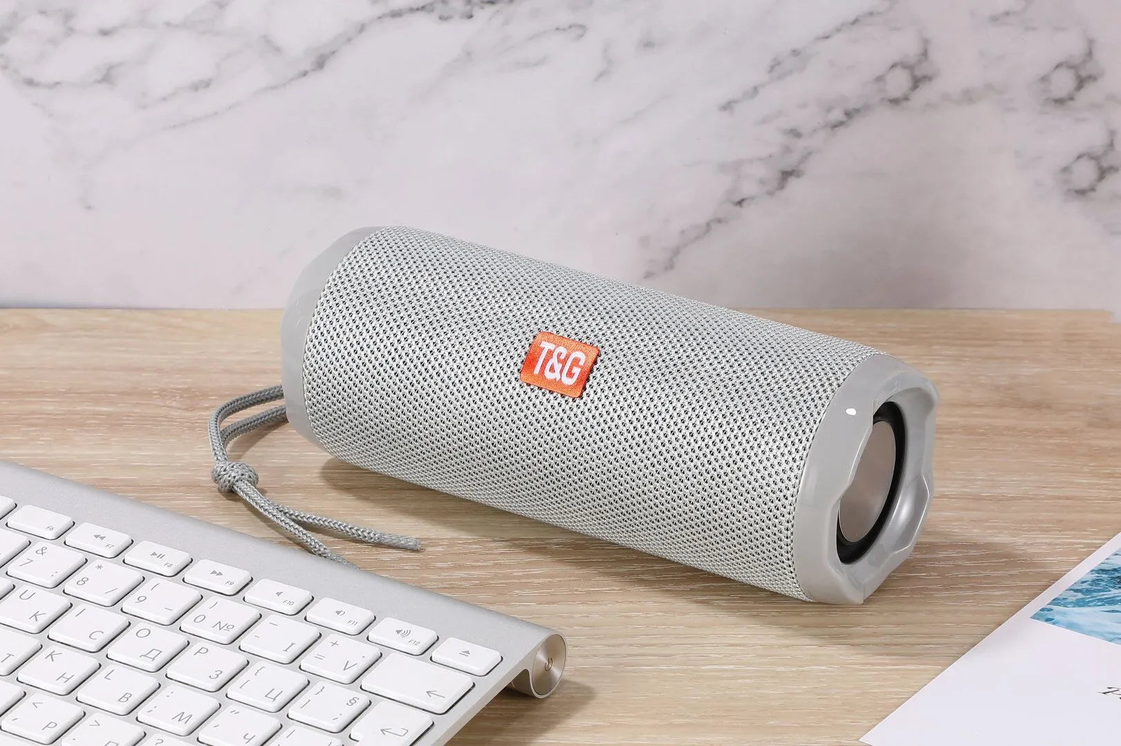 Fabric portable Bluetooth speaker with integrated card holder shown in multiple colour options.