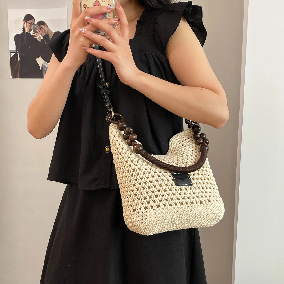 Knitted tote beach bag in bucket shape with contrast stitching and crossbody strap