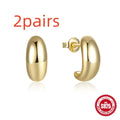 A pair of glossy C-shaped stud earrings in sterling silver, shown in gold and silver colour options.