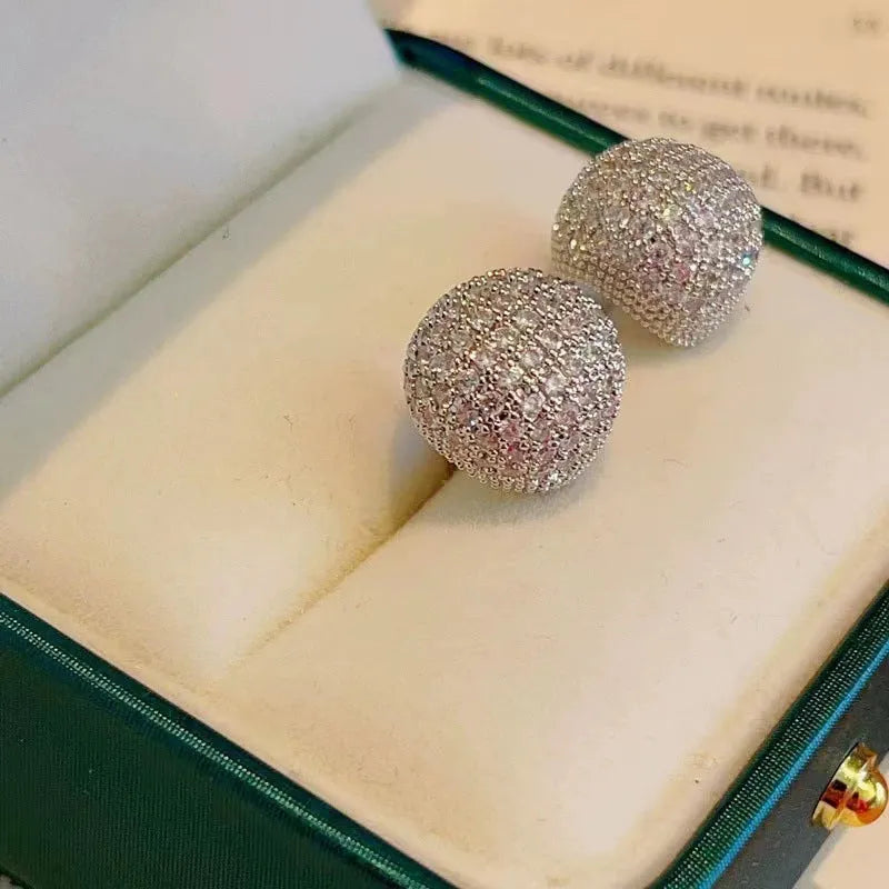 Gold and white geometric drop ear clip earrings with spherical bean design and full diamond flash