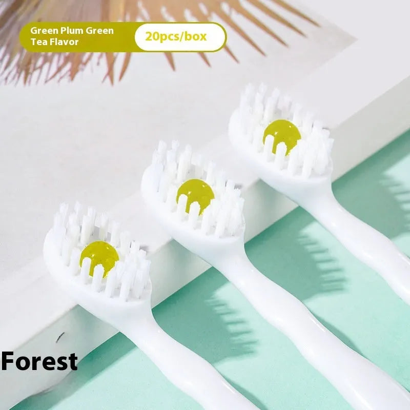 Box containing 20 small white disposable bead toothbrushes with compact rounded heads for travel.