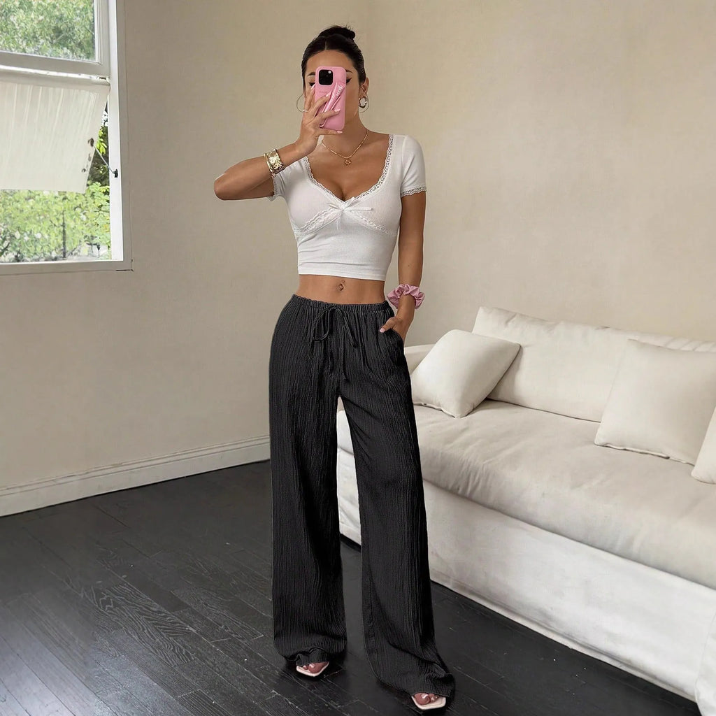 Women's wide leg trousers with lace-up waist detail in black or pink polyester fabric
