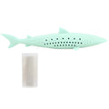 Green fish-shaped silicone chew toy for cats with visible side holes and a removable section for catnip.