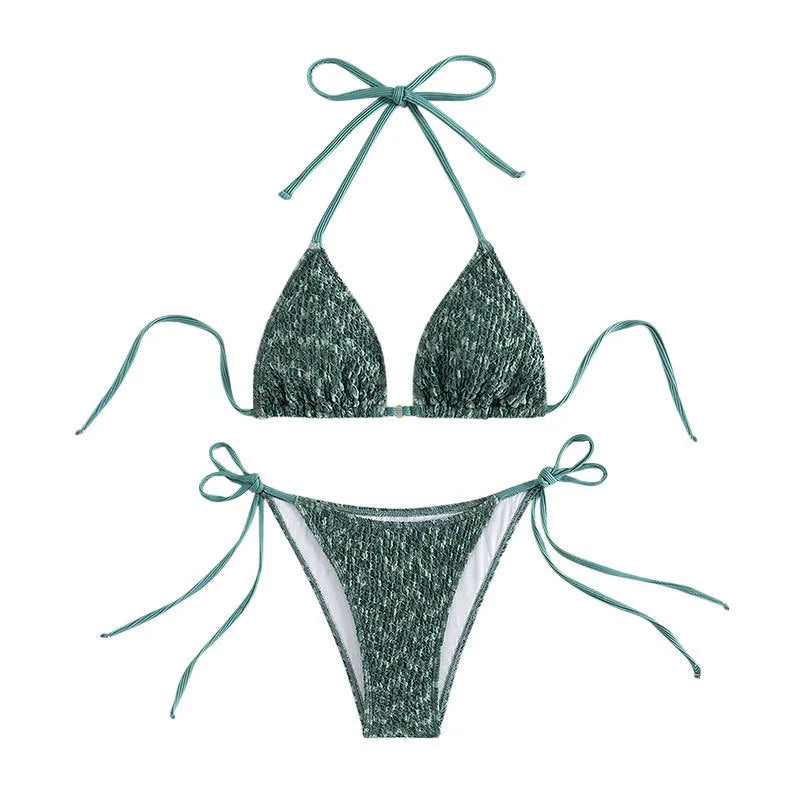 Green women's backless halter strap bikini set with matching shorts on a mannequin.