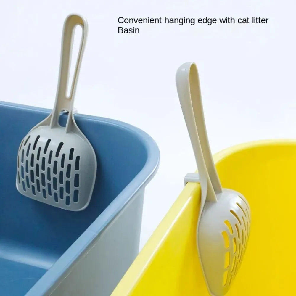 Grey plastic cat litter scoop resting on its matching comb-style base holder.