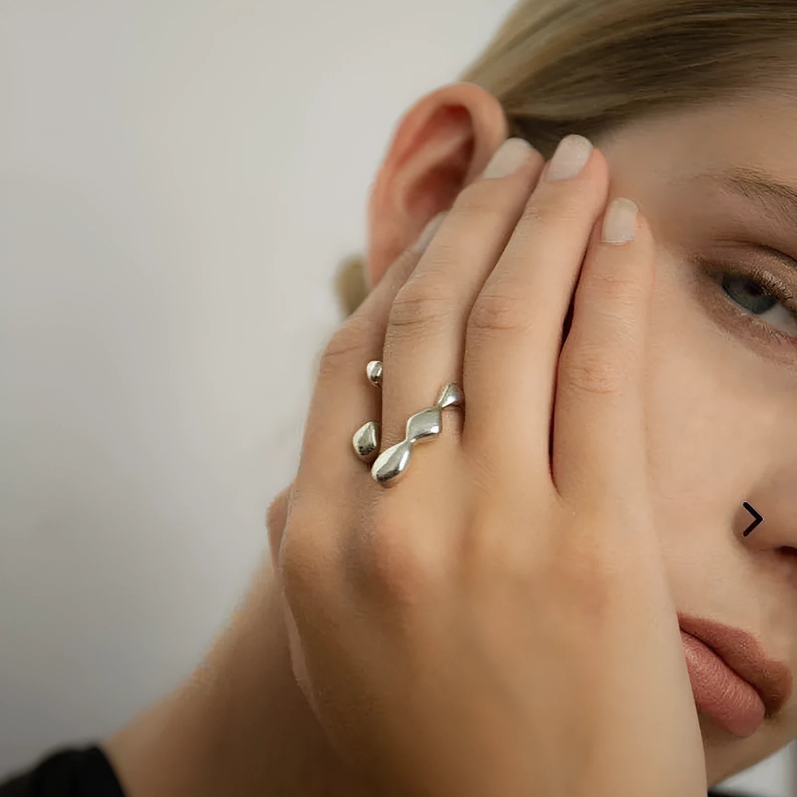 Brass adjustable fashion ring with spherical detail in gold or silver finish.