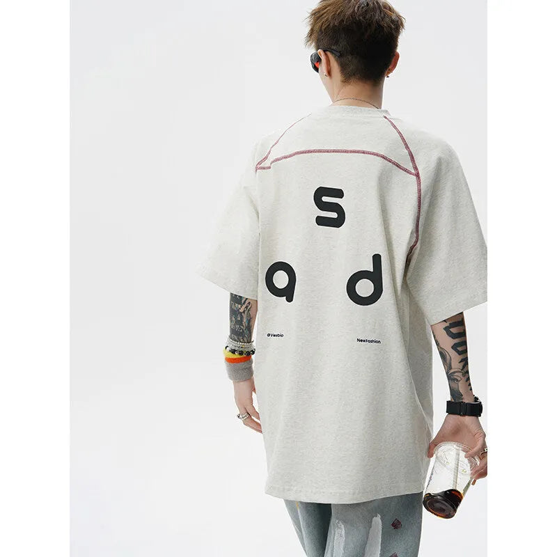 Men's loose fit cotton short-sleeve T-shirt with a printed letter design, shown in available colours.