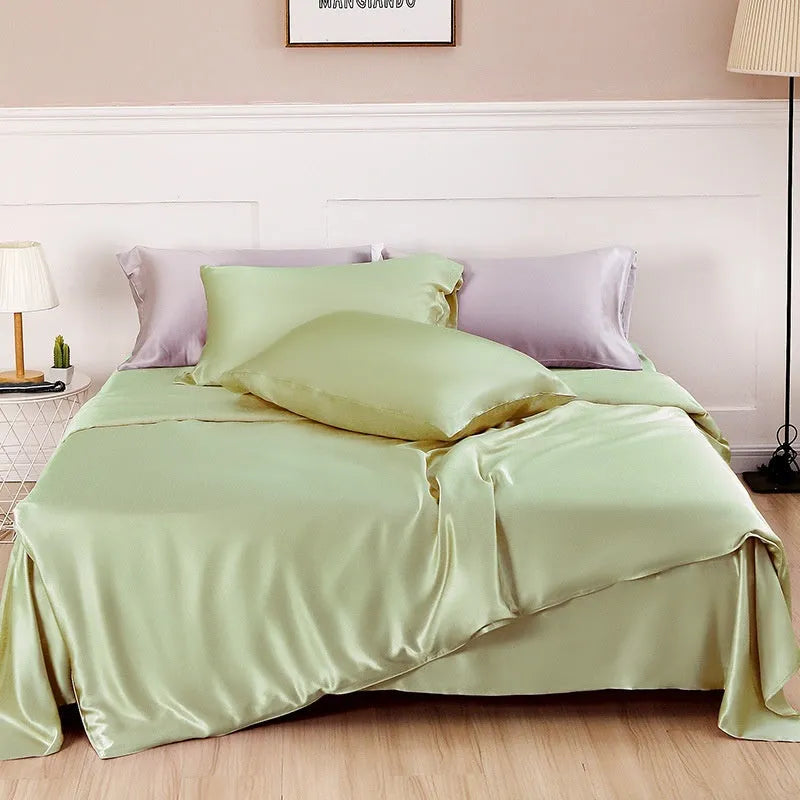 Double-sided solid colour silk duvet cover shown in Lotus Pink on a bed