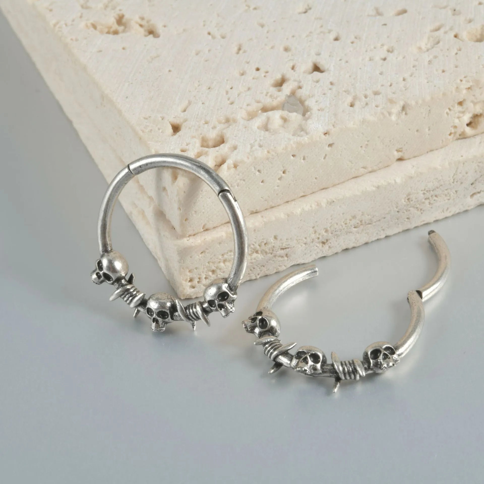 Copper punk earrings with embossed ghost head designs in antique gold and silver finishes