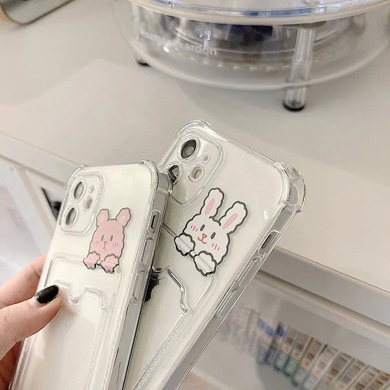 Transparent cartoon-design iPhone case with a card slot on the back, shown in colour options BQ2472 and BQ2473.