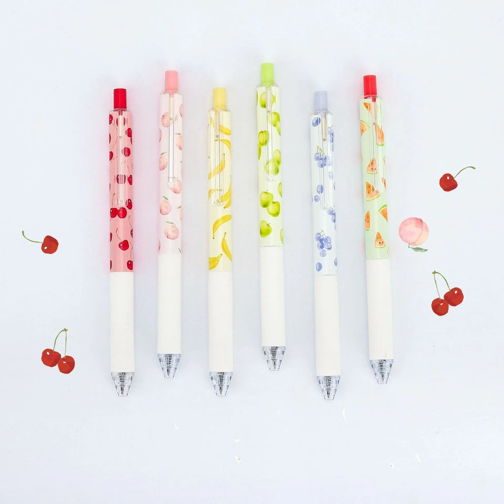 Three fruit-themed scented pressurised pens with 0.5mm black ink refills on writing surface