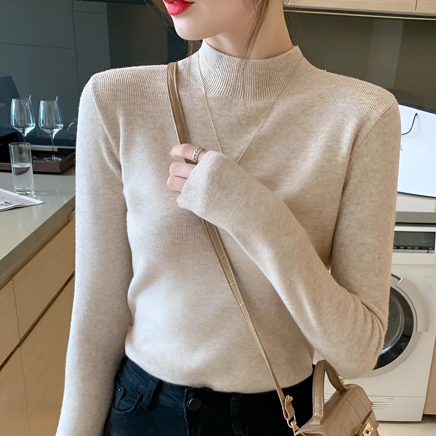 Women's slim fit long sleeve knitted top in viscose fibre shown in apricot colour.