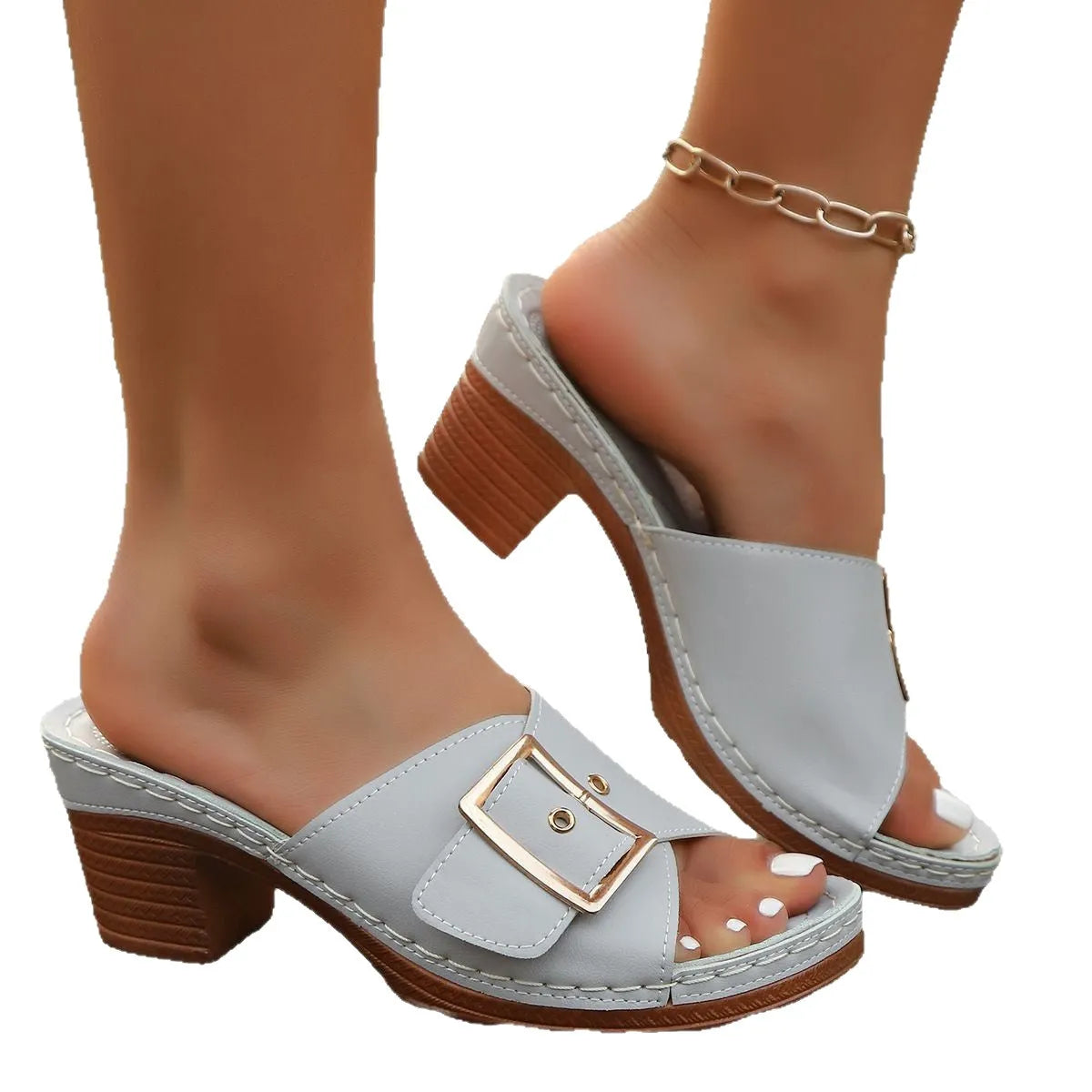 Women's black chunky heel slippers with a round toe and large metal buckle on a rubber sole.