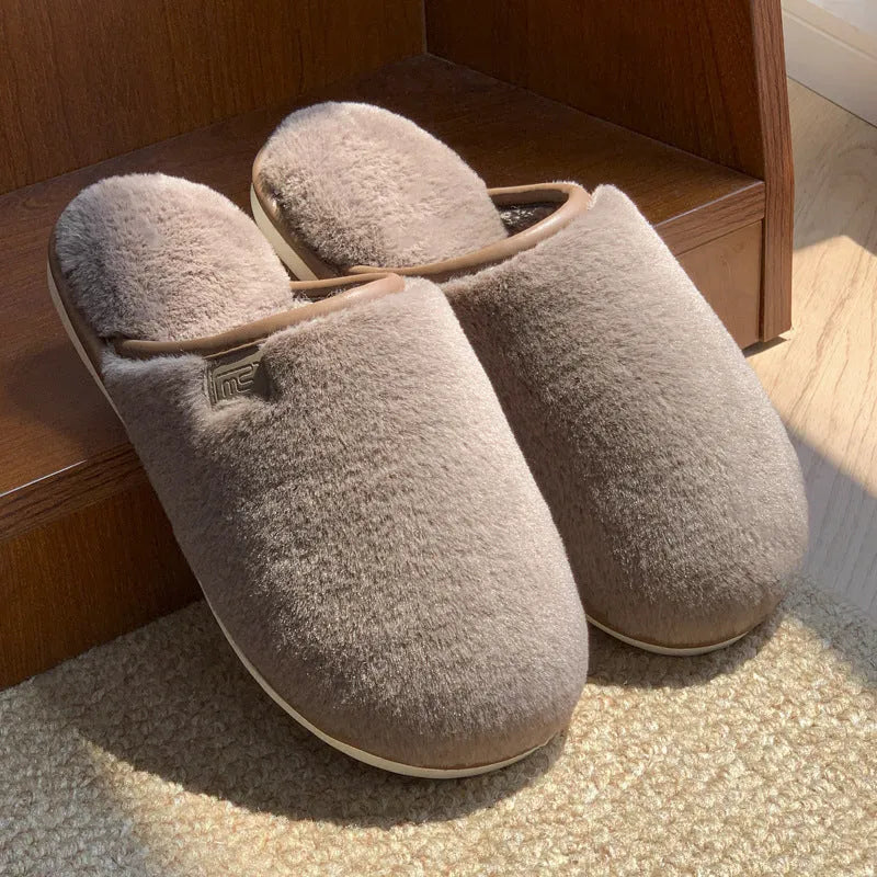 Solid-colour winter plush slippers with non-slip PVC sole on a home floor