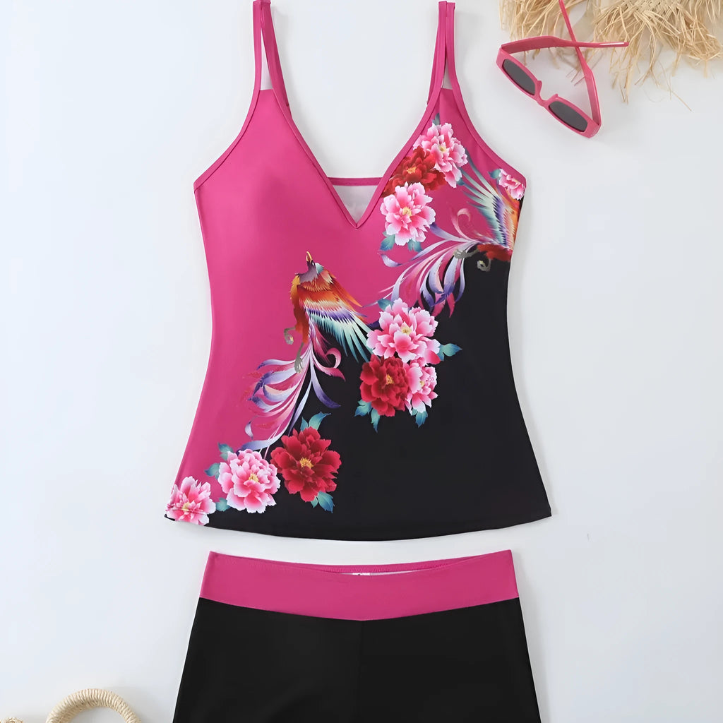 A plus size woman wearing a black two-piece printed swimsuit at the beach.