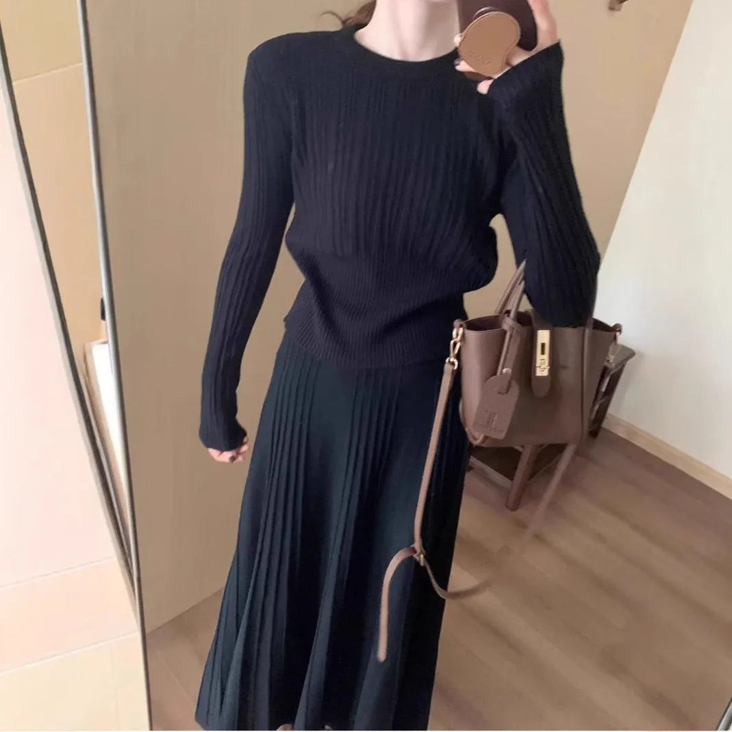 Women's knitted ethnic style dress suit with skirt showing 3D patterns in dark grey colour