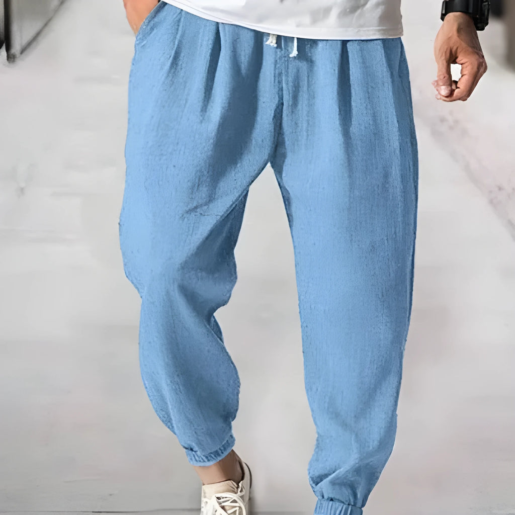Men's casual cotton trousers with ankle bands in light green colour showing loose fit design