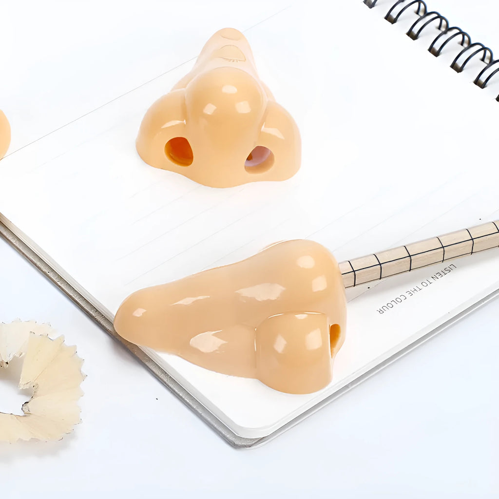 Flesh coloured plastic geometry design pencil sharpener with large casing, shown alongside a pencil.
