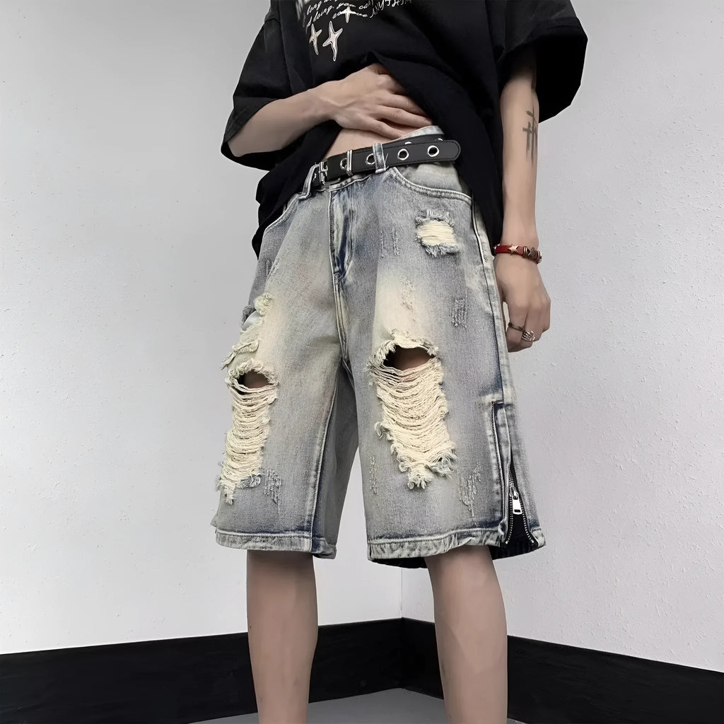 Blue retro-style denim shorts with a wide-leg loose fit and tattered detailing on a model.
