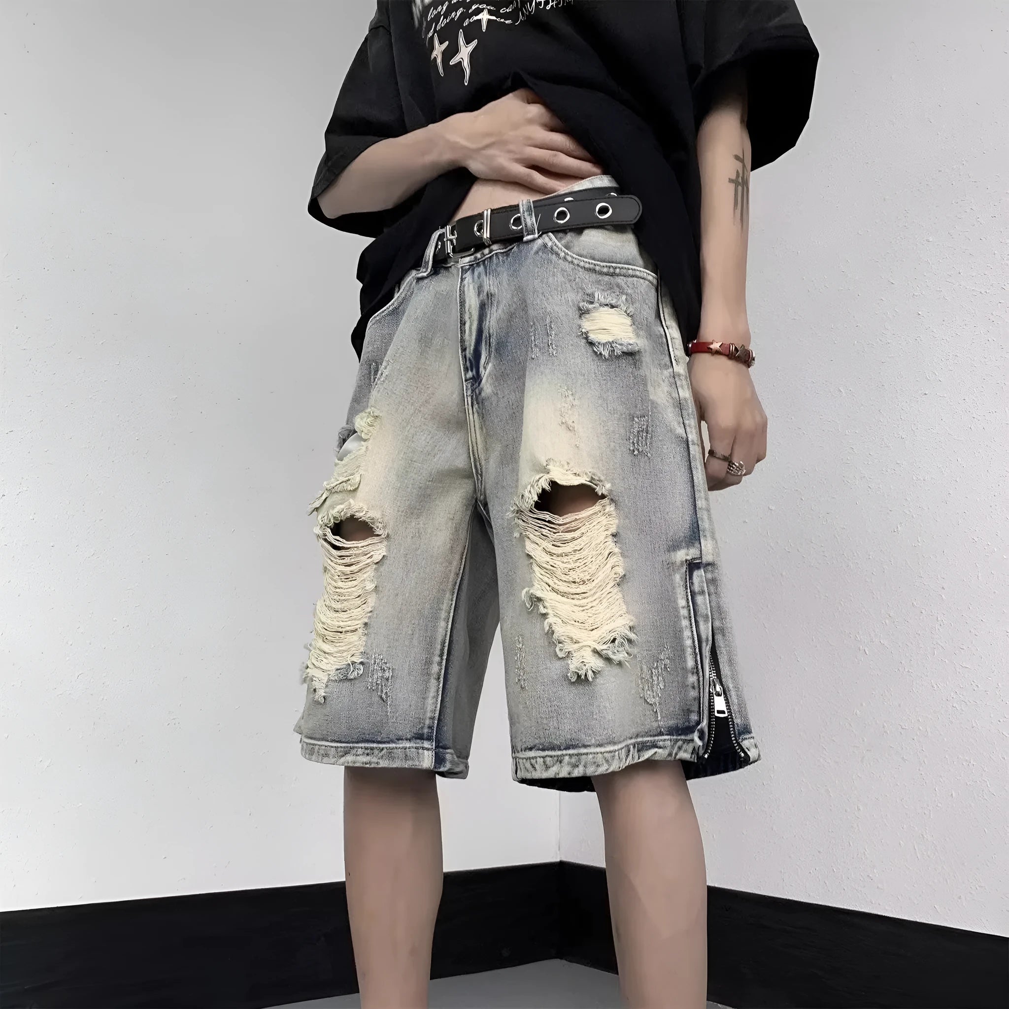 Blue retro-style denim shorts with a wide-leg loose fit and tattered detailing on a model.