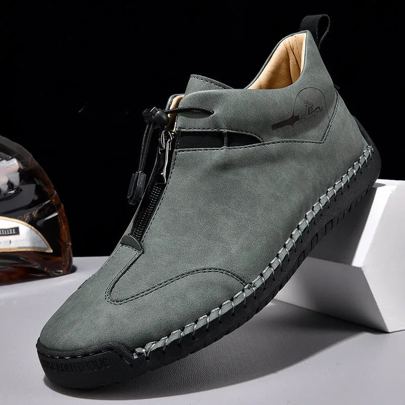 Men's black casual leather shoes with a mid-heel and rounded toe on a neutral background