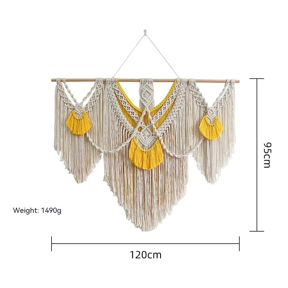 Hand-woven creamy white and yellow Nordic style cotton tapestry hanging on a wall
