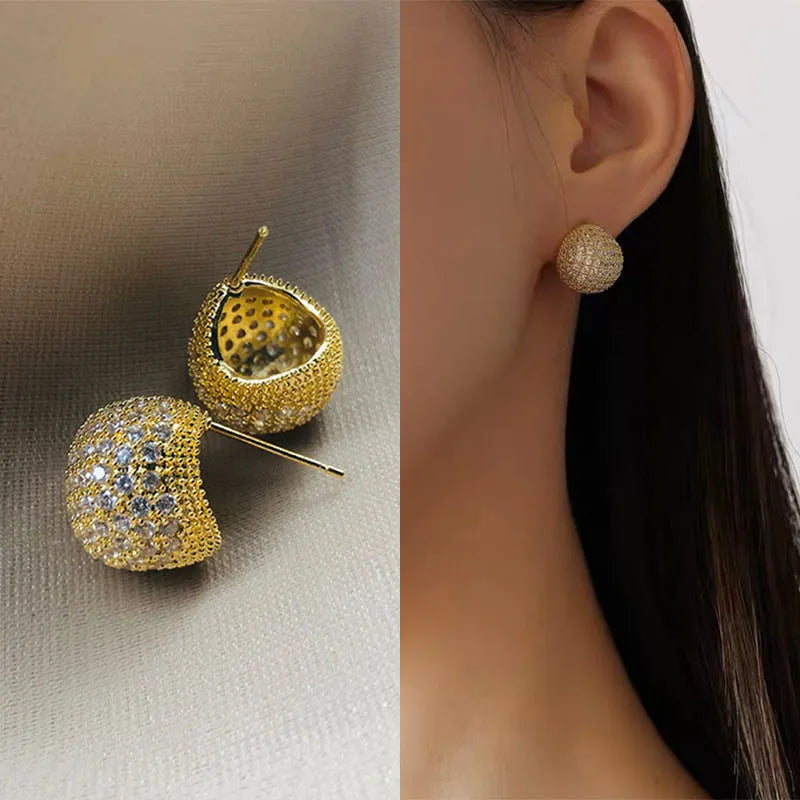 Gold and white geometric drop ear clip earrings with spherical bean design and full diamond flash