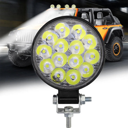 White mini round 42W LED work light with aluminium housing for vehicle mounting.