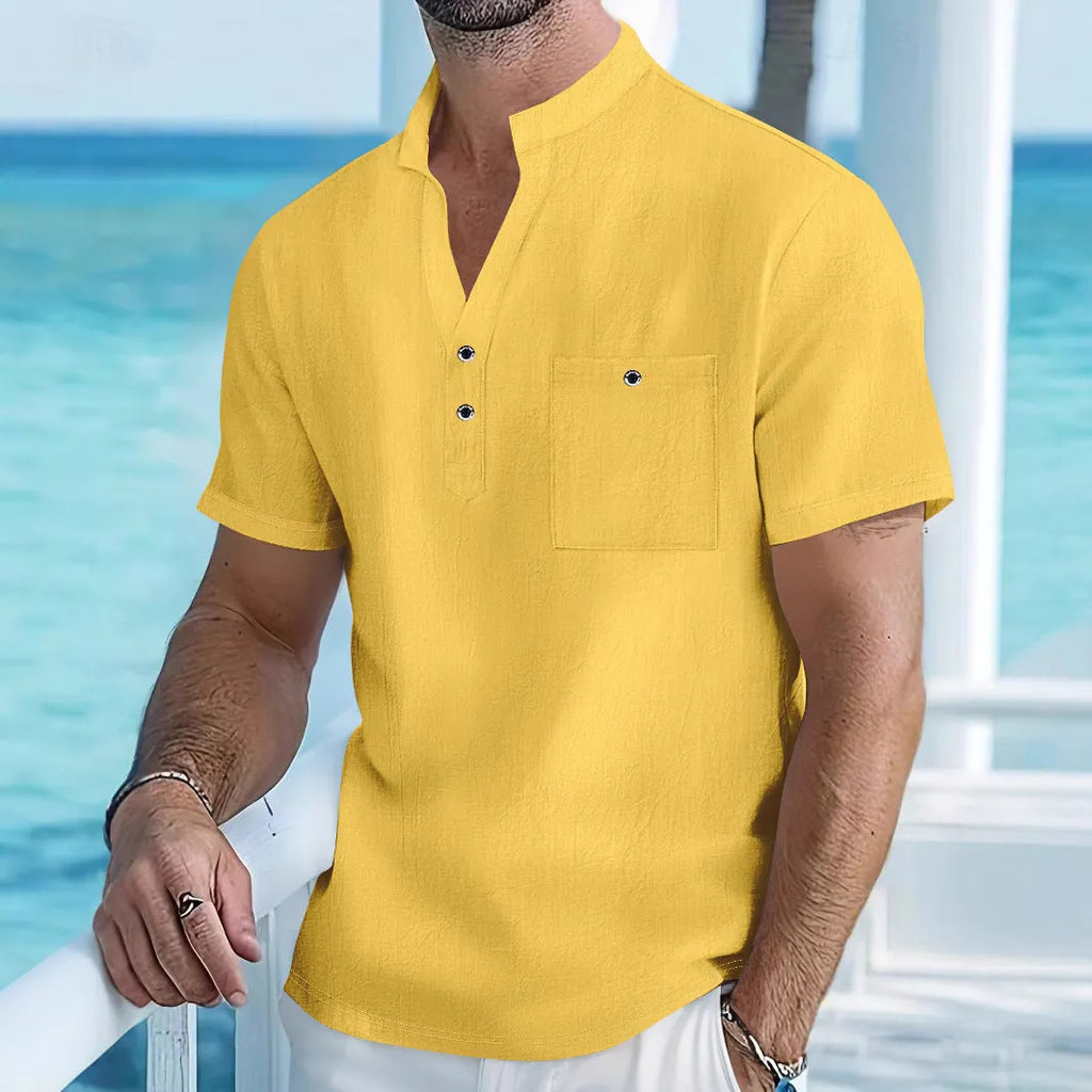 A man wearing a light-coloured linen blend stand collar t-shirt with short sleeves in a loose fit.