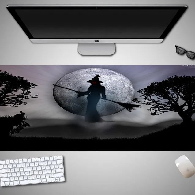 Oversized Halloween-themed rubber cloth mouse pad with non-slip base on a desk.