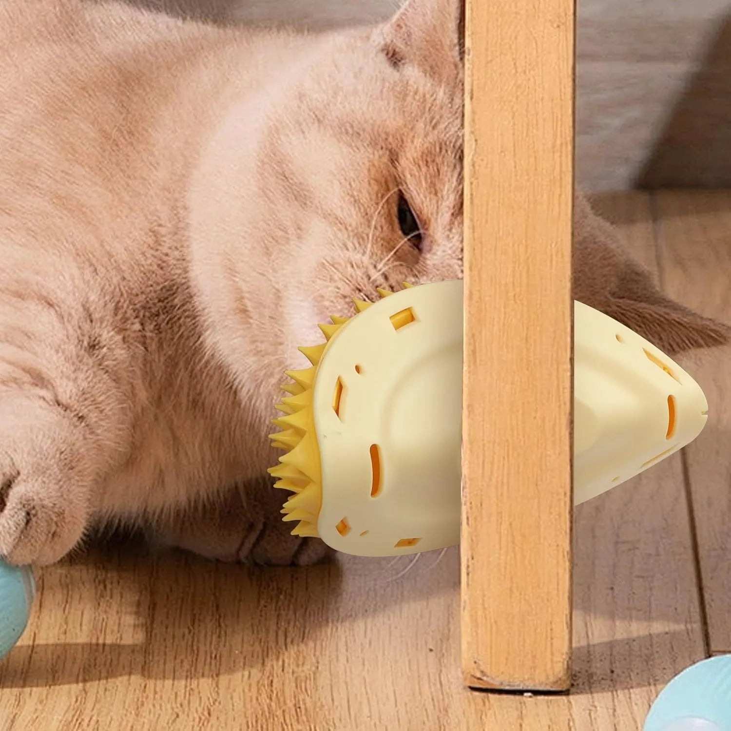 Yellow durian-shaped cat corner scratcher with massage brush installed on wall