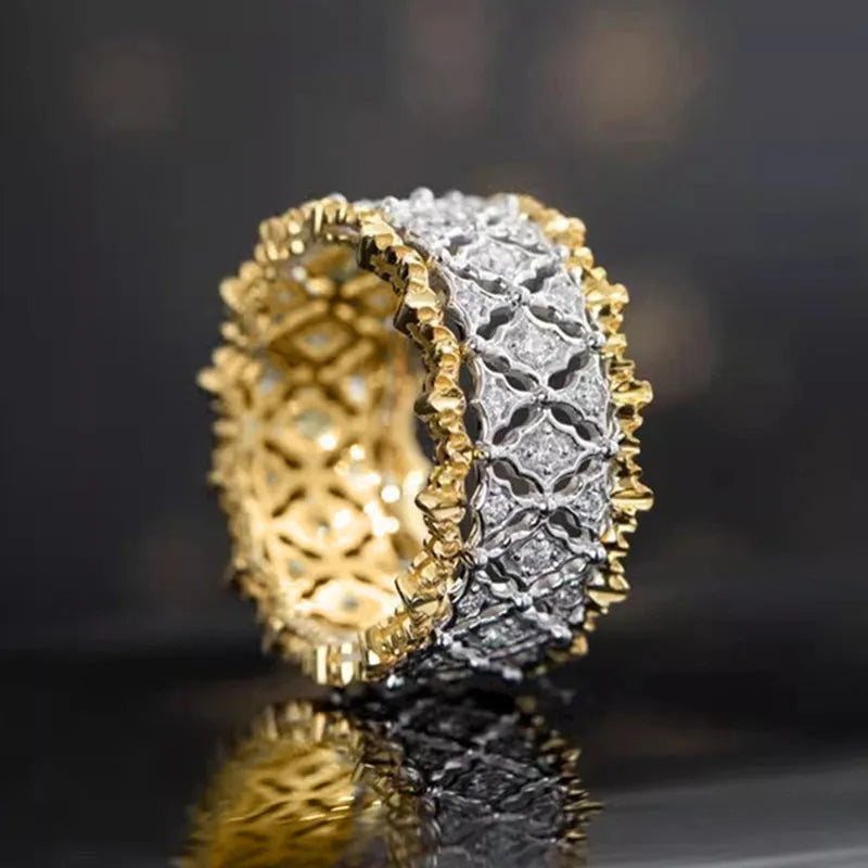 Geometric two-tone zircon ring with round elements on a copper base, shown in gold.