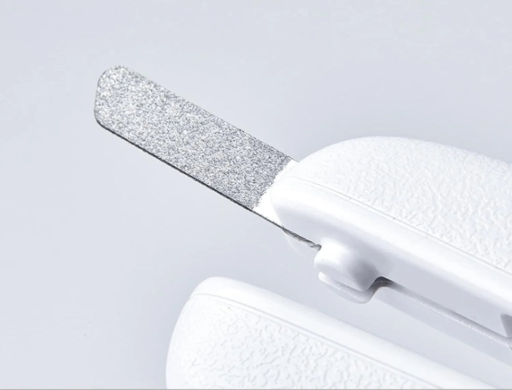 White LED pet nail clipper with a transparent anti-splash guard and a nail file on a white background.
