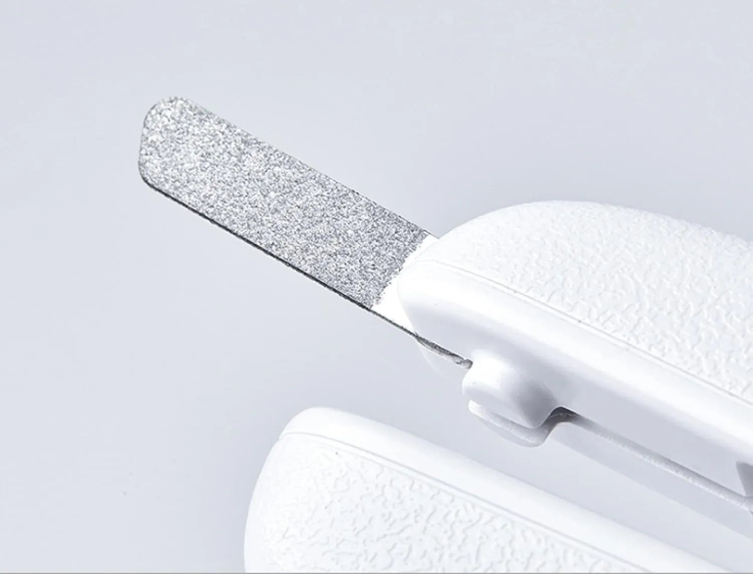 White LED pet nail clipper with a transparent anti-splash guard and a nail file on a white background.