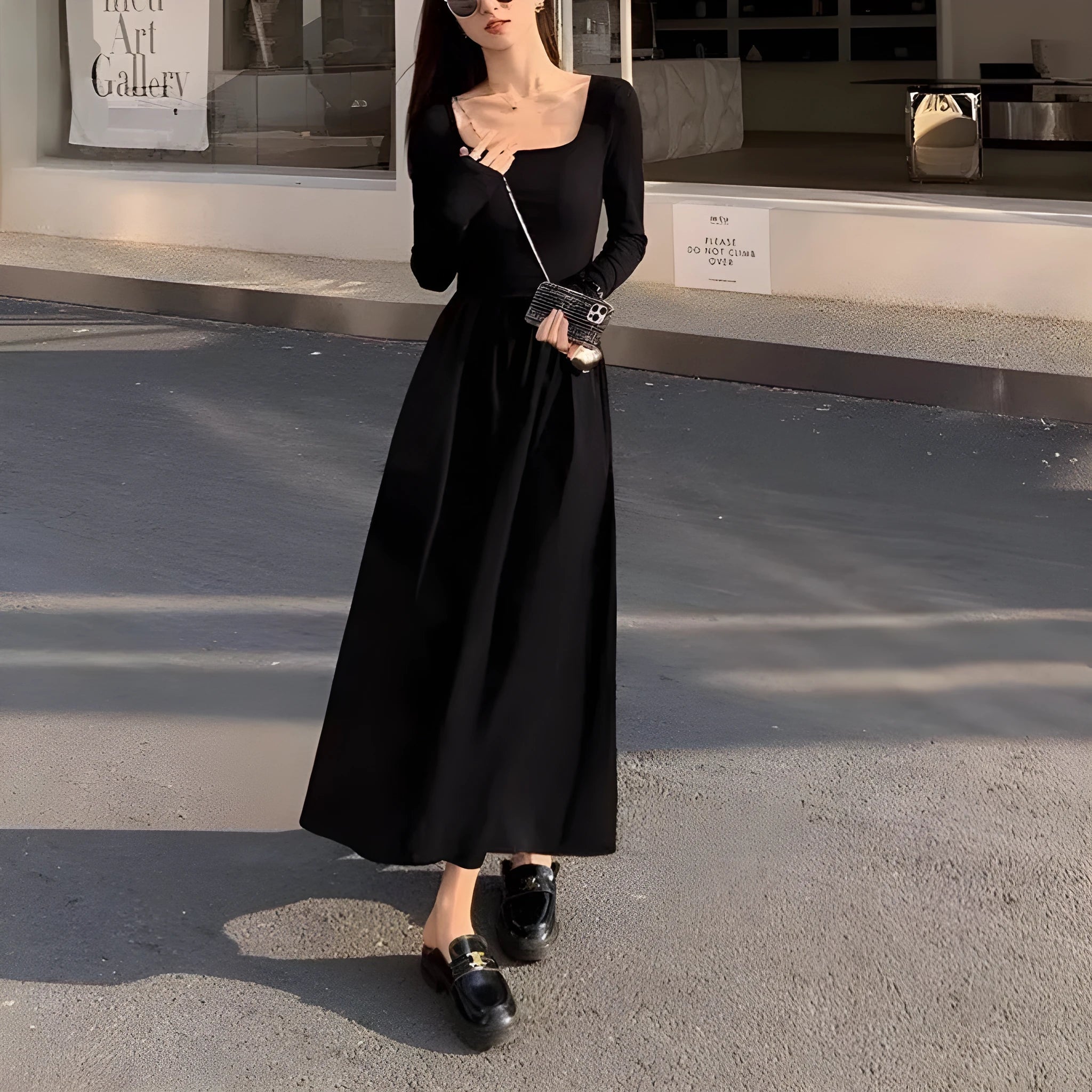 Women's black square collar knitted dress with long sleeves and an A-line skirt.