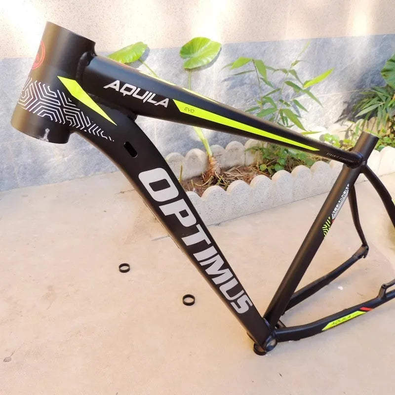 Black green aluminium mountain bike frame for 29-inch wheels with disc brake mounts and internal cable routing ports.