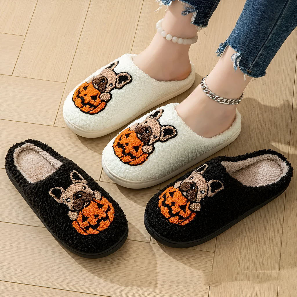 Black and white Halloween slippers with pumpkin pattern, plush upper, and textured rubber sole