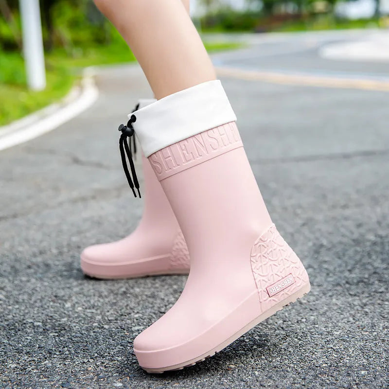 Women's solid colour PVC rain boots in apricot, shown with non-slip sole.